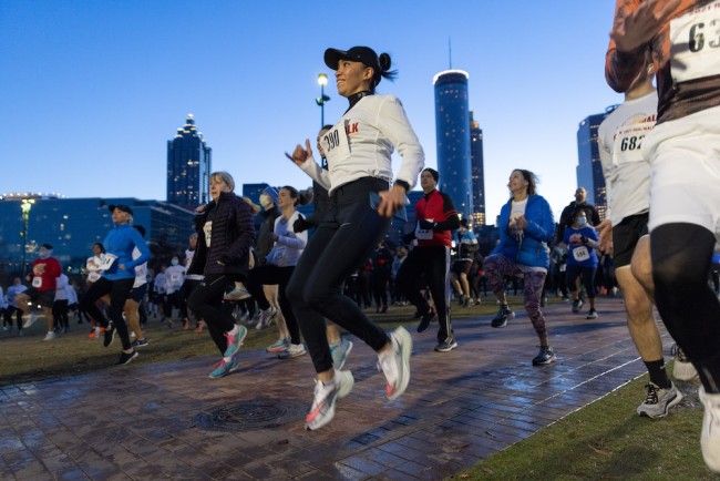 A women runner jumping into the air.