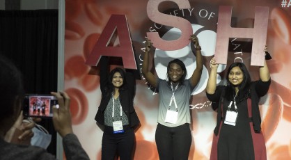 A group of volunteers posing with the ASH letters.